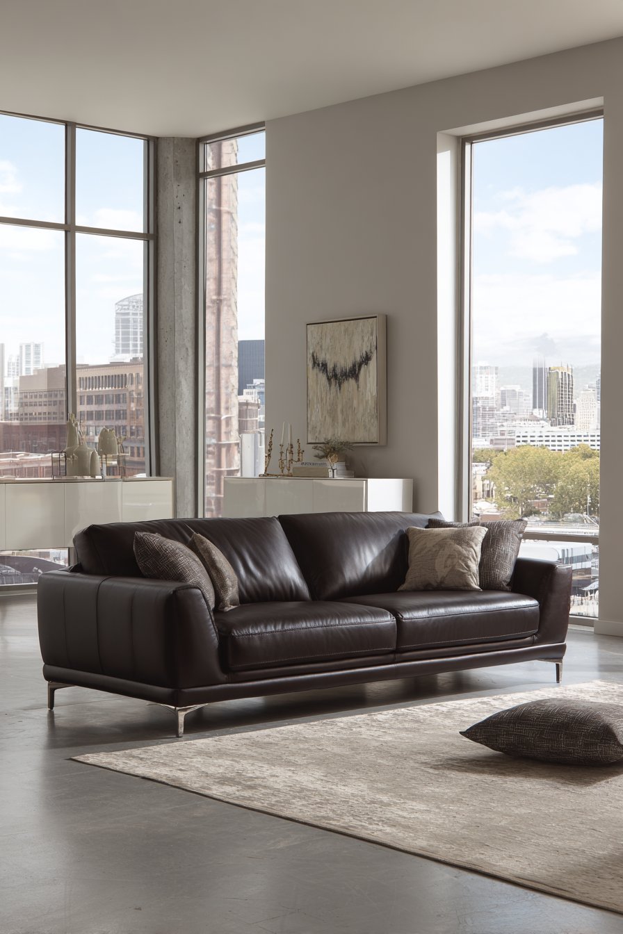 Sleek dark brown leather sofa with chrome legs