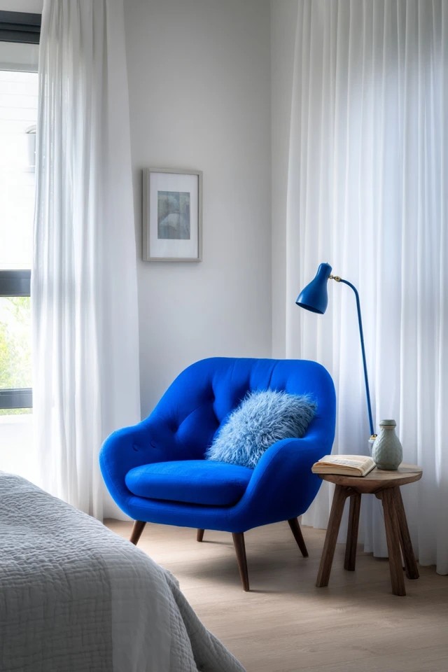 Vibrant blue upholstered chair with reading lamp