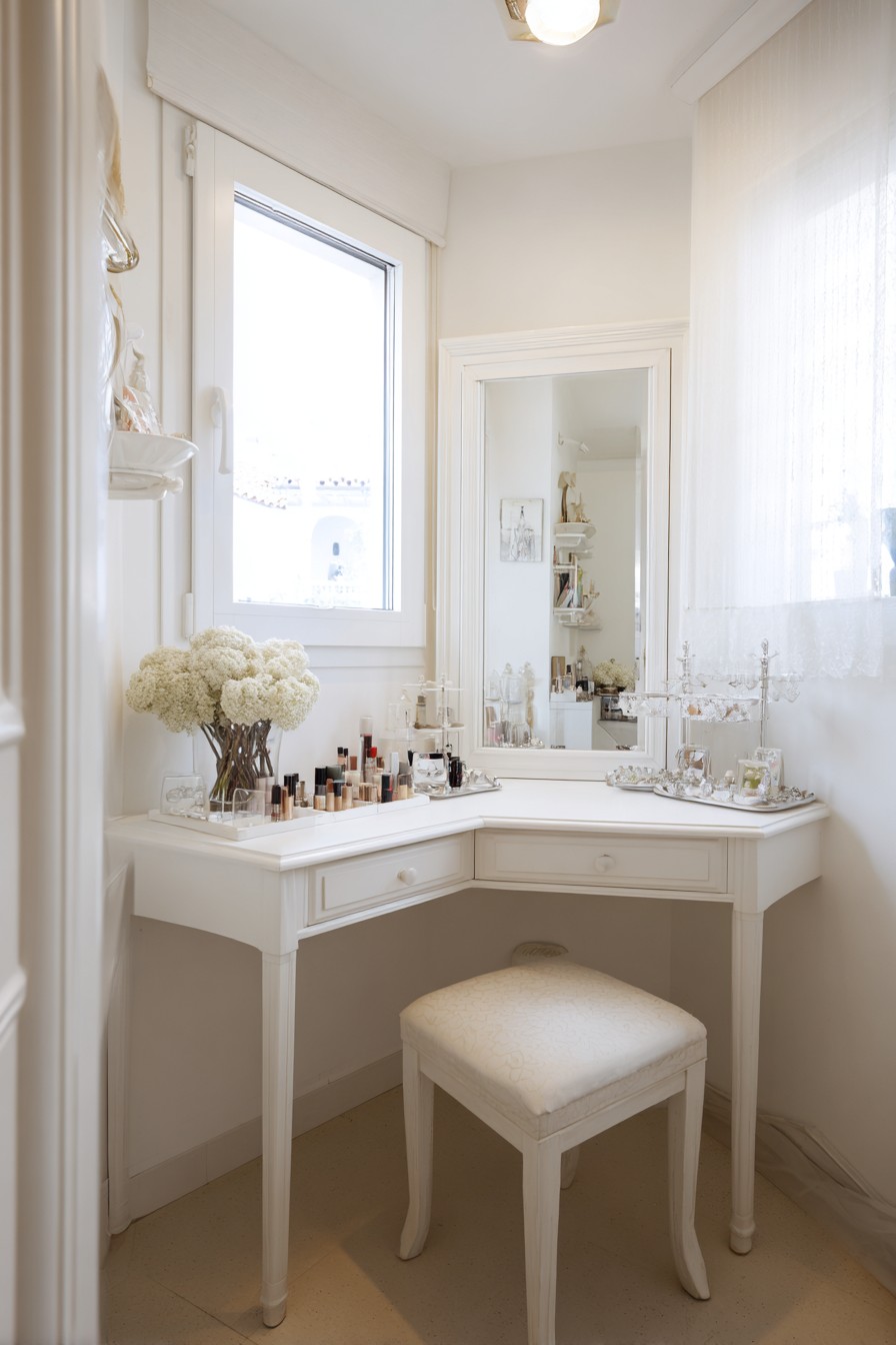 Angled corner vanity table with wall-mounted mirror