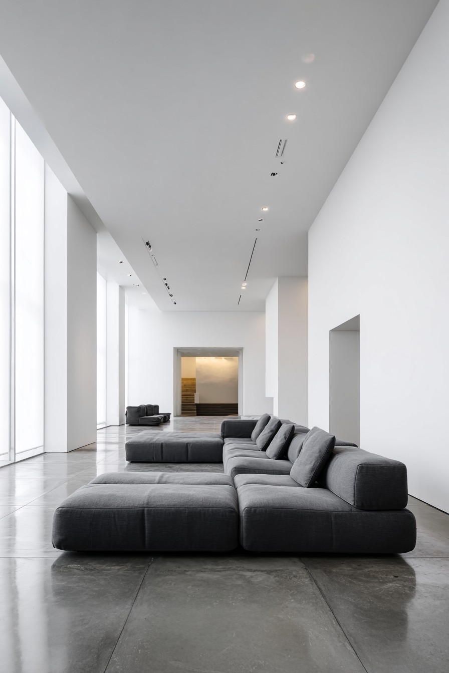 Charcoal grey modular sofa in otherwise empty room