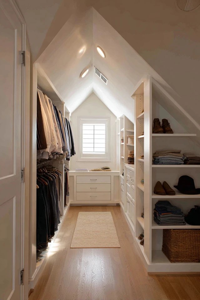 Floor-to-ceiling built-in wardrobe system fitted along attic knee walls maximising hanging and shelving capacity