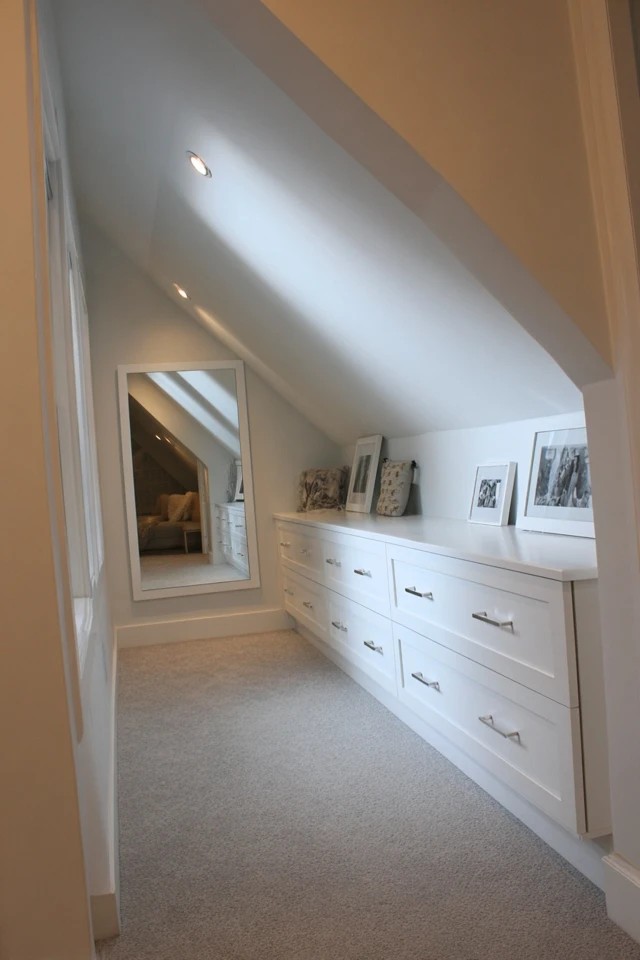 Whites, soft beiges, and light greys creating a serene restful colour palette in a peaceful attic bedroom