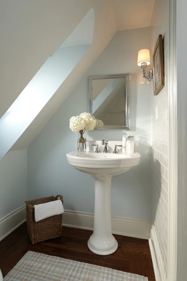 Horizontal white shiplap planks creating fresh cottage character in a charming attic bathroom