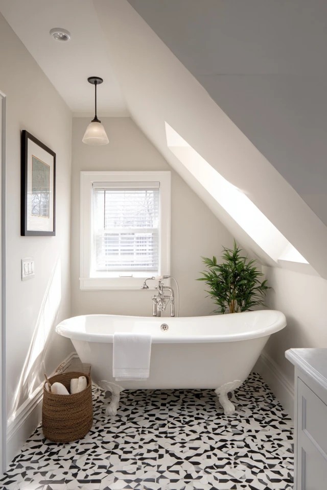 Custom built-in drawers and shelves fitted into the low eaves space creating clever storage in an attic bathroom