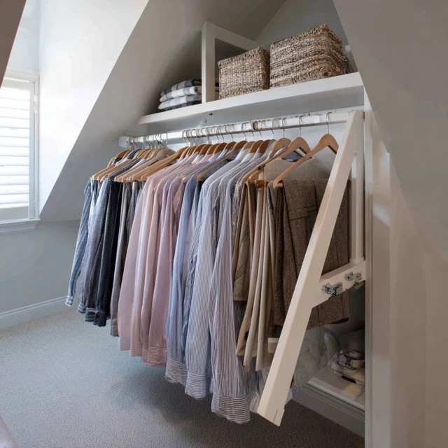 Pull-out belt and tie rack keeping accessories visible and wrinkle-free in the attic walk-in closet cabinetry