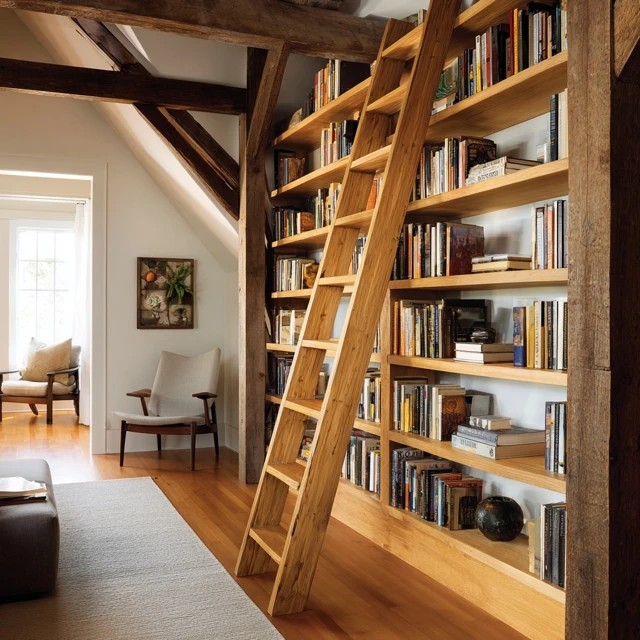 Angled leaning bookshelf providing flexible additional book storage in an attic library corner