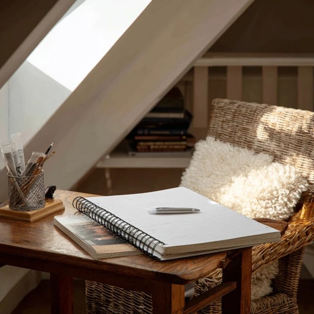 Dedicated reading journal and pen holder creating a literary reflection station in an attic library