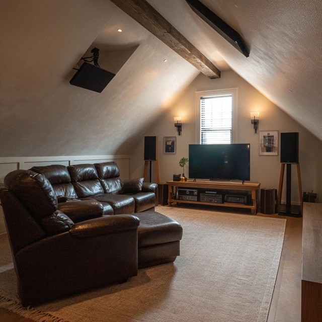 Surround sound speakers mounted in the attic TV room for immersive cinematic audio experience